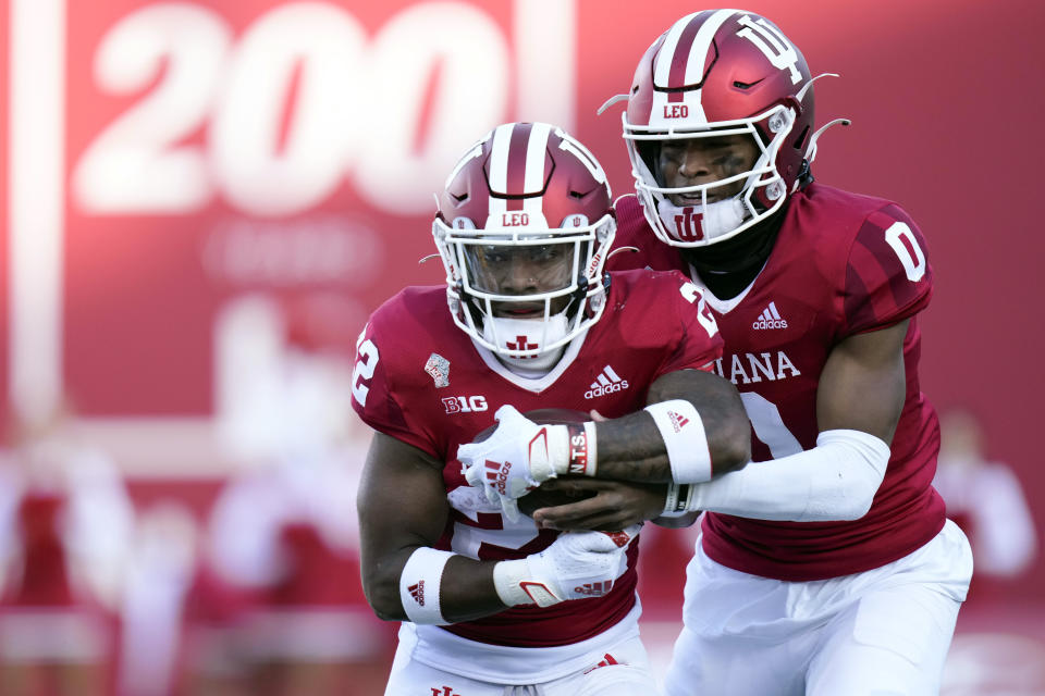 Indiana quarterback Donaven McCulley (0) hands off to running back Davion Ervin-Poindexter (22) while playing against Minnesota in the first half during an NCAA college football game in Bloomington, Ind., Saturday, Nov. 20, 2021. (AP Photo/AJ Mast)