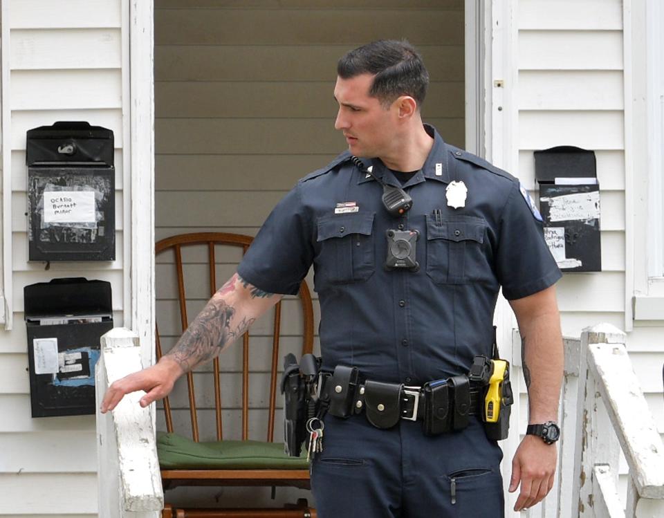 A Worcester police officer investigates a call on Shannon Street  on May 1, 2019., while wearing a body camera.