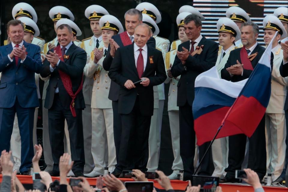 Vladimir Putin is applauded after speaking at a gala concert marking Victory Day in Sevastopol, Crimea, on 9 May 2014. (AP)