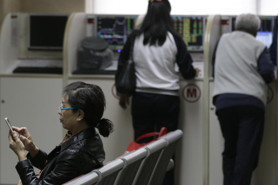 Chinese investors check stock prices at a brokerage house in Beijing, Wednesday, April 24, 2019. Shares were mostly lower in Asia on Wednesday despite the S&P 500’s all-time record high close the day before. (AP Photo/Andy Wong)