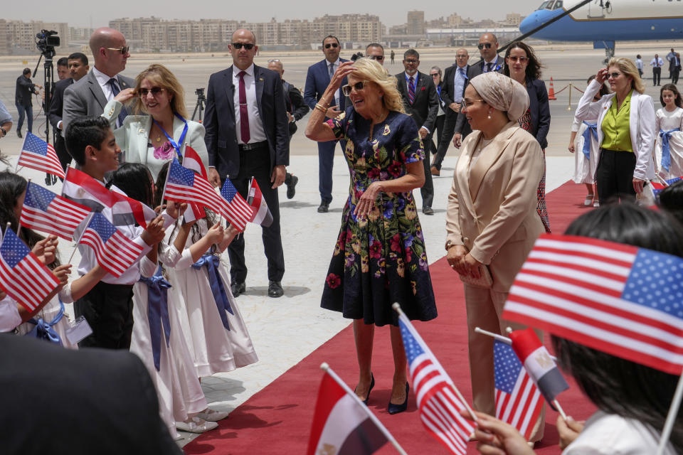First Lady Jill Biden, center, accompanied by Egyptian First Lady Entissar Mohameed Amer is greeted by children as she arrives at Cairo International Airport in Cairo, Friday, June 2, 2023. (AP Photo/Amr Nabil, Pool)