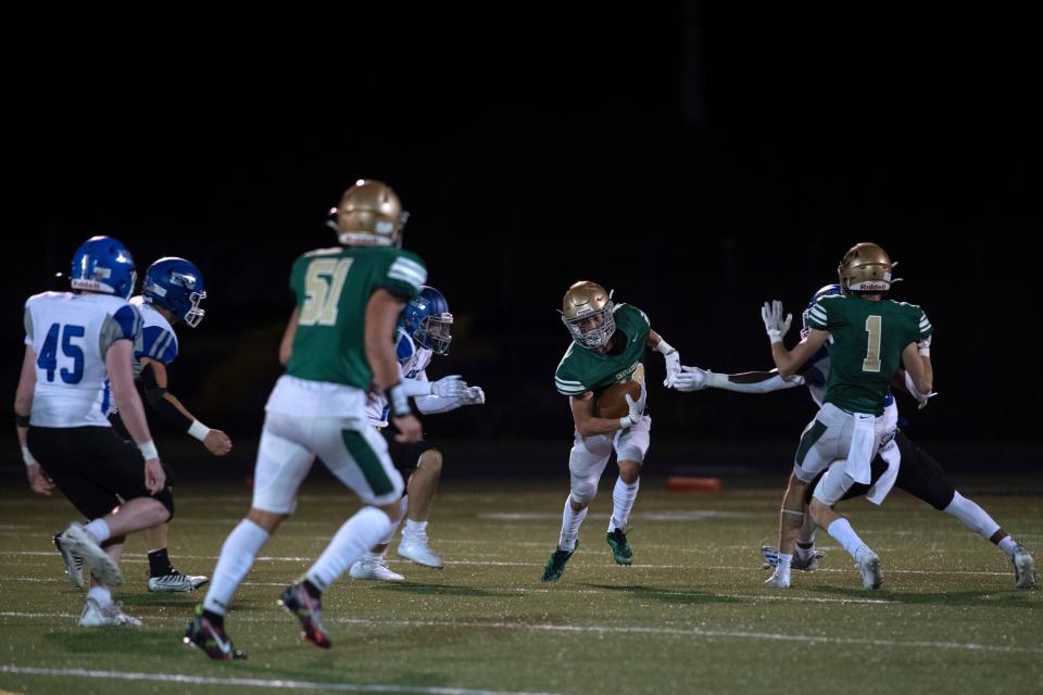 Lansdale Catholic junior Ian Gramlich looks to carry down the field at Harry S. Truman High School football field in Levittown on Friday, Sept. 23, 2022. Lansdale Catholic defeated Conwell-Egan Catholic 10-0.