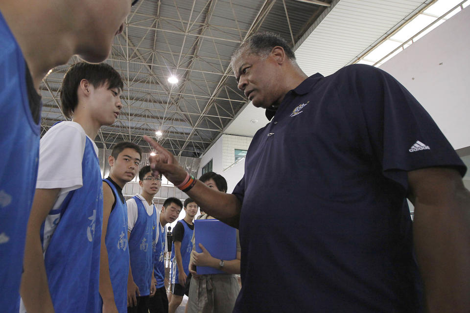 FILE - In this Sept. 7, 2009, file photo, former Washington Bullets legend Wes Unseld teaches a student at a basketball clinic at Nanyang Model High School in Shanghai. Unseld, the Hall of Fame center who led Washington to its only NBA championship and was chosen one of the 50 greatest players in league history, died Tuesday, June 2, 2020, after a series of health issues, most recently pneumonia. He was 74. (AP Photo/Eugene Hoshiko, FIle)