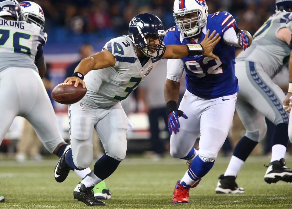 TORONTO, ON - DECEMBER 16: Russell Wilson #3 of the Seattle Seahawks is flushed out of the pocket during an NFL game by Alex Carrington #92 of the Buffalo Bills at Rogers Centre on December 16, 2012 in Toronto, Ontario, Canada. (Photo by Tom Szczerbowski/Getty Images)