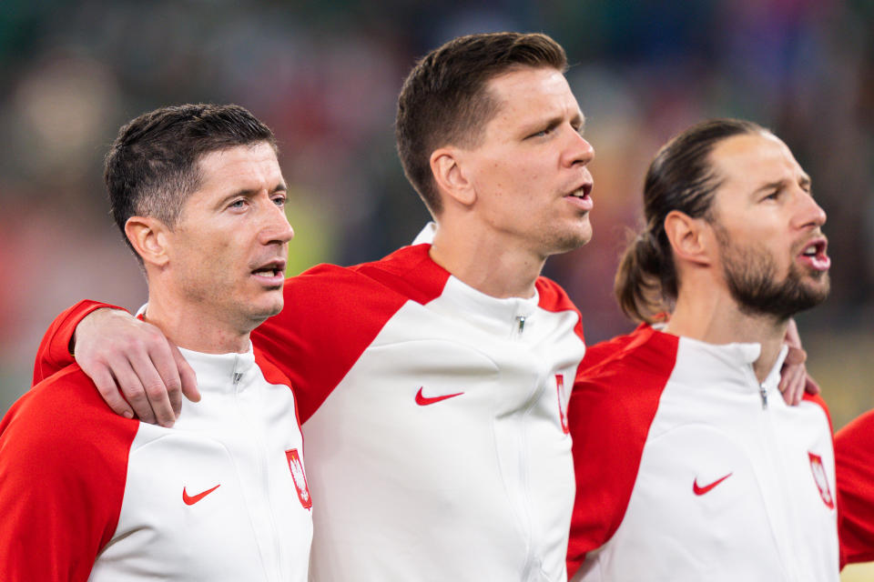 DOHA, QATAR - NOVEMBER 22: Polands Robert Lewandowski, Wojciech Szczesny and teammate sing the national anthem at the beginning of the 2022 FIFA World Cup group C match between Mexico and Argentina on November 22, 2022, at Stadium 974 in Doha, Qatar. (Photo by Richard Gordon/Icon Sportswire via Getty Images)
