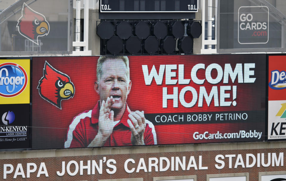 A sign posted on the scoreboard of Papa John's Cardinal Stadium welcomes the return of Bobby Petrino as the Louisville Cardinals new head football coach Thursday, Jan. 9, 2014, in Louisville, Ky. (AP Photo/Timothy D. Easley)