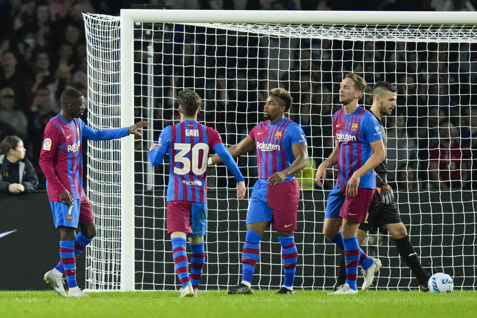 Barcelona's Ousmane Dembele, left, is congratulated by teammates after scoring his team's first goal against the A-League All Stars' during their friendly soccer match at Stadium Australia in Sydney, Australia, Wednesday, May 25, 2022. (AP Photo/Rick Rycroft)