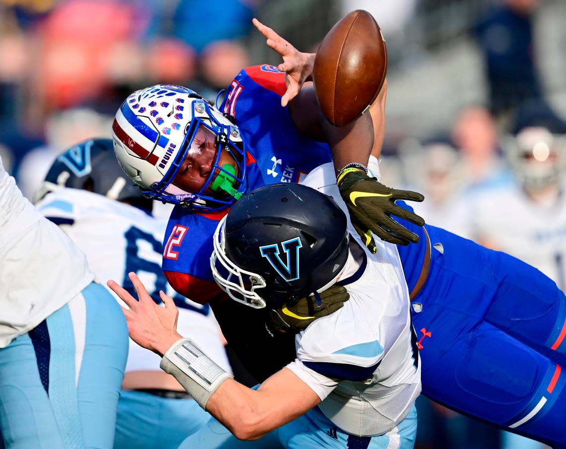 Blake Purchase (12), right, forces a fumble from Valor Christian Eagles QB Asher Weiner (14) in the first quarter of the 2022 Colorado 5A State Championship game at Empower Field at Mile High Stadium in Denver, Colo. on Saturday, Dec. 3, 2022. Creek recovered which led to a field goal.