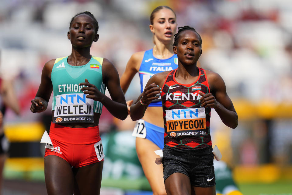 Faith Kipyegon, of Kenya and Diribe Welteji, of Ethiopia finish a Women's 1500-meters heat during the World Athletics Championships in Budapest, Hungary, Saturday, Aug. 19, 2023. (AP Photo/Petr David Josek)