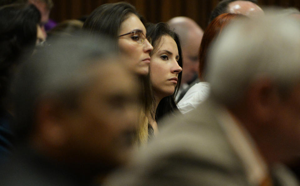 Sister of Oscar Pistorius, Aimee Pistorius, right, sits in court on the tenth day of proceedings in Pretoria, South Africa, Friday March 14, 2014. Pistorius is charged with the shooting death of his girlfriend Reeva Steenkamp on Valentines Day in 2013. (AP Photo/Phill Magakoe, Pool)
