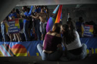 Thousands of people lined canals, bridges and underpasses in the Dutch capital to watch the colorful spectacle of the Pride Canal Parade return for the 25th edition after the last two events were canceled due to the COVID-19 pandemic, in Amsterdam, Netherlands, Saturday, Aug. 6, 2022. (AP Photo/Peter Dejong)