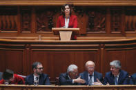 Leader of CDS-PP party Assuncao Cristas delivers a speech as Portugal's Prime Minister Antonio Costa shakes hands with Finance Minister Mario Centeno during the debate of a motion of censure at the parliament in Lisbon, Portugal February 20, 2019. REUTERS/Rafael Marchante