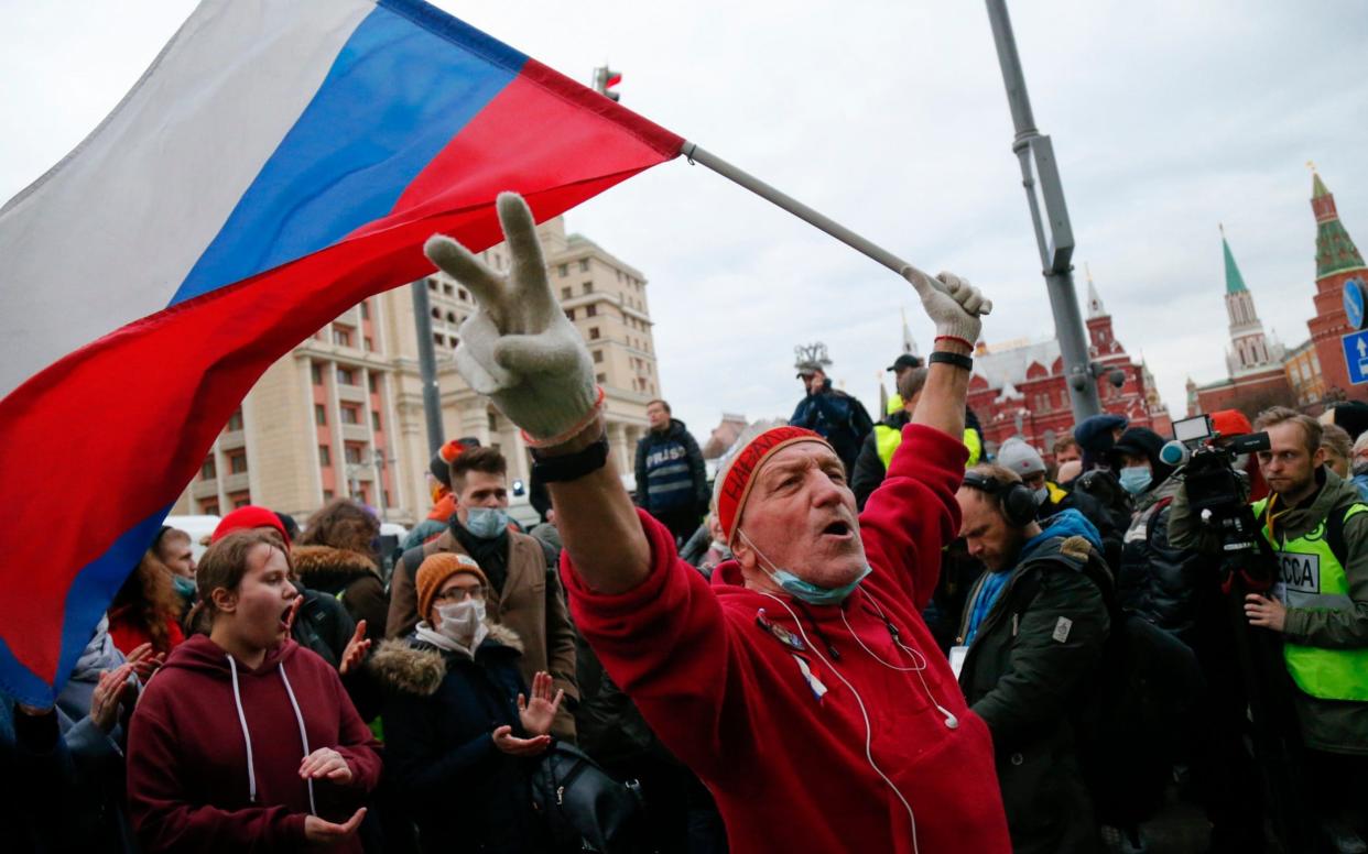 A supporter waves a Russian flag and shouts slogans during the opposition rally in support of jailed opposition leader Alexei Navalny in Moscow - Alexander Zemlianichenko /AP
