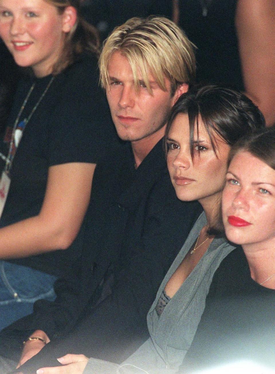 Victoria and David Beckham attend a London Fashion Week show on September 25, 1998.