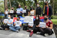 A small group gather in Alameda Park to protest against the participation of Venezuela’s President Nicolas Maduro in the Community of Latin American and Caribbean States, CELAC, summit in Mexico City, Saturday, Sept. 18, 2021. CELAC has only existed for 10 years and is more left-leaning, having remained on good terms with countries including Cuba, Venezuela and Nicaragua. (AP Photo/Ginnette Riquelme)