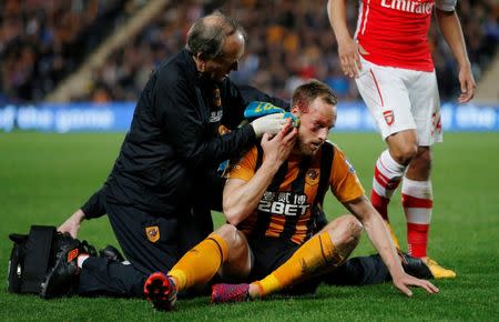 Hull City's David Meyler receives treatment after sustaining a facial injury at the Kingston Communications Stadium May 4, 2015. Reuters / Lee Smith
