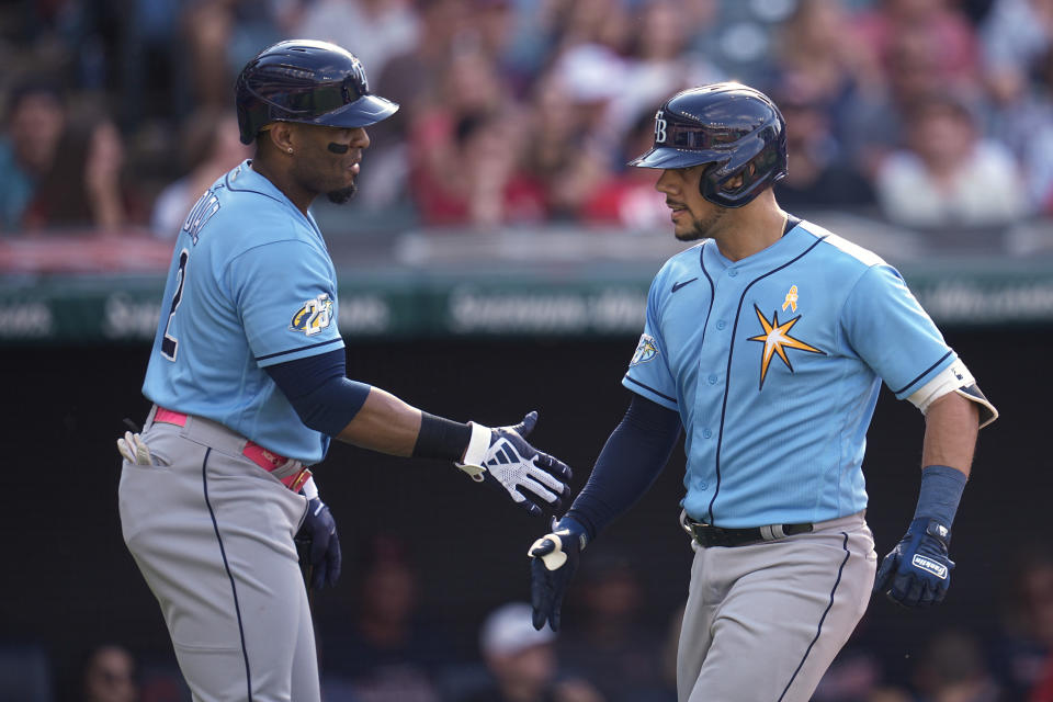 Tampa Bay Rays' Rene Pinto, right, is congratulated by Yandy Díaz, left, after hitting a home run in the third inning of a baseball game against the Cleveland Guardians. Sunday, Sept. 3, 2023, in Cleveland. (AP Photo/Sue Ogrocki)