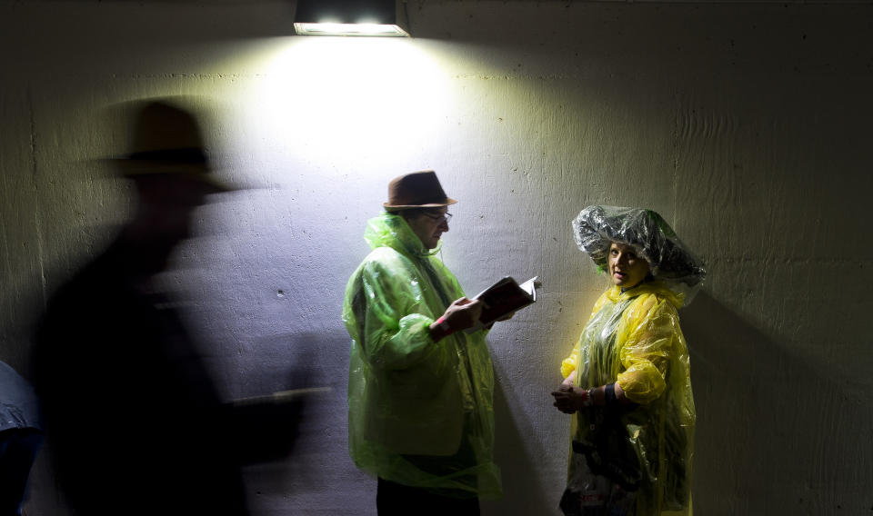 <p>Fans crowd the tunnel to escape the downpour on Kentucky Derby Day at Churchill Downs on May 5, 2018 in Louisville, Ky. (Photo: Scott Serio/Eclipse Sportswire/Getty Images) </p>