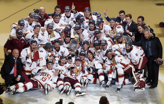 Denver players celebrate their 3-2 win over Minnesota-Duluth during an NCAA Frozen Four championship college hockey game, Saturday, April 8, 2017, in Chicago. (AP Photo/Nam Y. Huh)