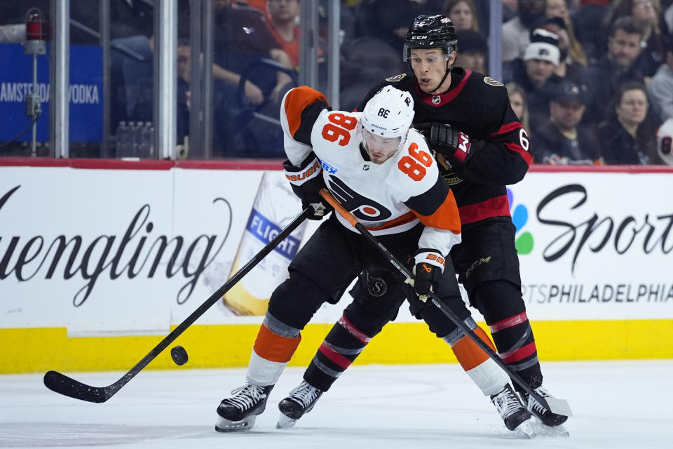 Philadelphia Flyers' Joel Farabee, left, and Ottawa Senators' Jakob Chychrun battle for the puck during the third period of an NHL hockey game, Saturday, March 2, 2024, in Philadelphia. (AP Photo/Matt Slocum)