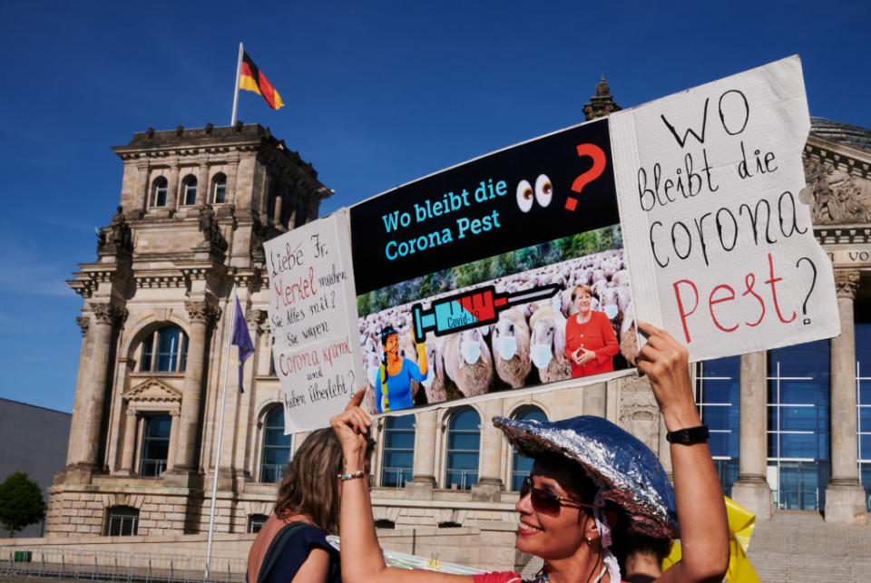 dpatop - 31 July 2020, Berlin: A demonstrator holds up a sign saying "Where is the Corona Plague?" In front of the Reichstag, the rally "Democratic Resistance" "for the restoration of constitutional democracy" took place. Photo: Annette Riedl/dpa (Photo by Annette Riedl/picture alliance via Getty Images)