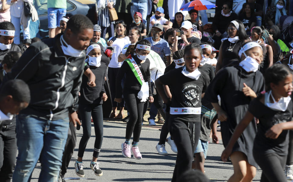 People dance to Jerusalema in Cape Town, South Africa, Thursday, Sept. 24, 2020. South Africans of all walks of life are dancing to “Jerusalema,” a rousing anthem to lift their spirits amid the battle against COVID-19. In response to a call from President Cyril Ramaphosa to mark the country’s Heritage Day holiday Thursday, people from townships to posh suburbs are doing line dances to the tune. (AP Photo/Nardus Engelbrecht)