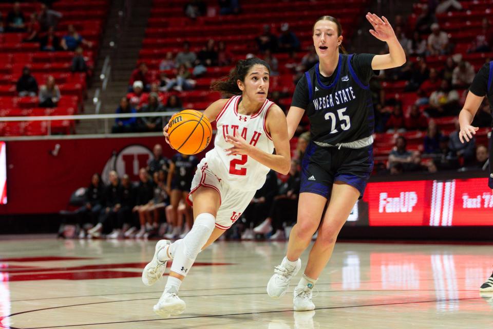 Utah Utes guard Ines Vieira (2) dribbles the ball with Weber State Wildcats forward Taylor Smith (25) on defense during the women’s college basketball game between the University of Utah and Weber State University at the Jon M. Huntsman Center in Salt Lake City on Thursday, Dec. 21, 2023. | Megan Nielsen, Deseret News