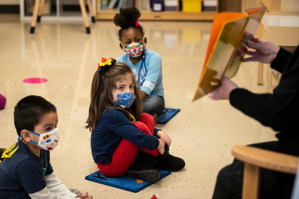 Pre-kindergarten students listen as their teacher reads a story at Dawes Elementary in Chicago, Monday, Jan. 11, 2021.