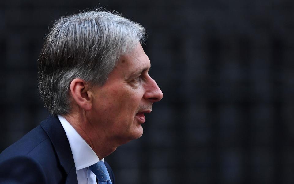 Beleagured: Philip Hammond announced a shock U-turn over planned tax hikes for the self-employed today - Credit: AFP