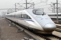 The high speed train that runs on the new 2,298-kilometre (1,425-mile) line between Beijing and Guangzhou runs into Xuchang East Station in Xuchang, central China's Henan province on December 26, 2012. China started service on December 26 on the world's longest high-speed rail route, the latest milestone in the country's rapid and -- sometimes troubled -- super fast rail network. The opening of this new line means passengers will be whisked from the capital to the southern commercial hub in just eight hours, compared with the 22 hours previously required. CHINA OUT AFP PHOTO