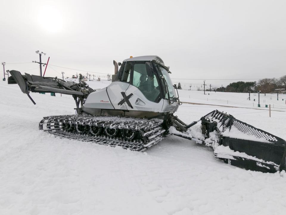 Snow groomers smooth the slopes of Mt. Brighton Wednesday, Dec. 1, 2021, after snow-making machines build a base.