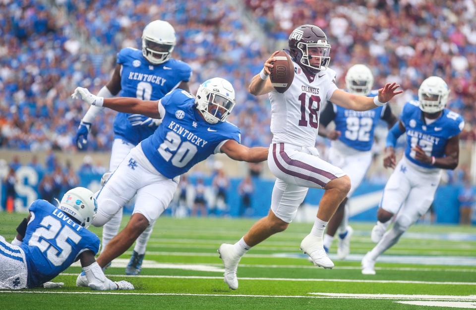 Eastern Kentucky Colonels quarterback Parker McKinney sidesteps Kentucky Wildcats linebacker Keaten Wade to score the game's first touchdown early in the first quarter Sept. 9 in Lexington.