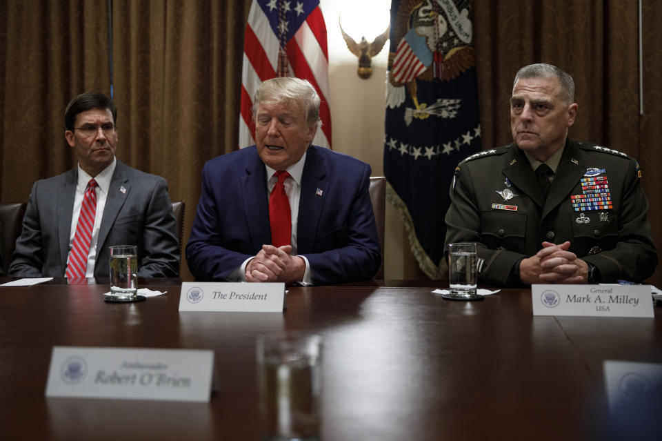 President Donald Trump, joined by from left, Defense Secretary Mark Esper, and Chairman of the Joint Chiefs of Staff Gen. Mark Milley, speaks to media during a briefing with senior military leaders in the Cabinet Room at the White House in Washington, Monday, Oct. 7, 2019. (AP Photo/Carolyn Kaster)