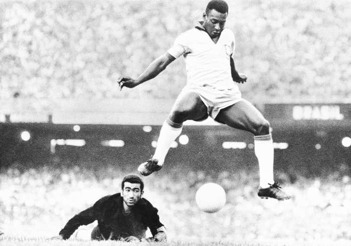 Brazil's Pelé scores as Venezuela's goalkeeper Fabrizio Fasano looks on during a game in Rio de Janeiro, Brazil, in August 1969.