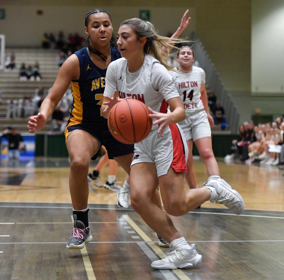 Hilton's Elena Graziano, right, drives to the basket against Averill Park's Tatiana Tune during a NYSPHSAA Class AA Girls Basketball Championships semifinal in Troy, N.Y., Friday, March 15, 2024. Hilton advanced to the Class AA final with a 73-71 overtime win against Averill Park-II.