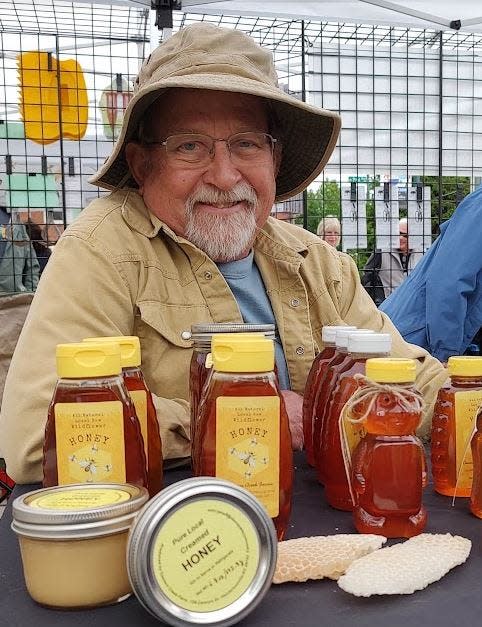 Local beekeeper Gary Clements has honey for sale at a farmers market recently.