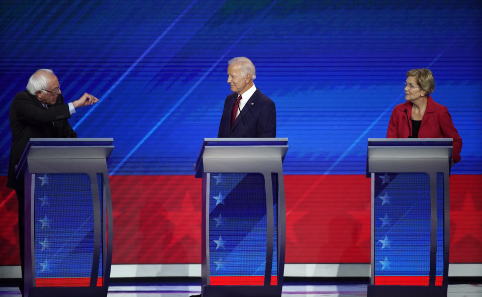 Former Vice President Joe Biden, center, and Sen. Elizabeth Warren, D-Mass., right, listen as Sen. Bernie Sanders, I-Vt., left, speaks Thursday, Sept. 12, 2019, during a Democratic presidential primary debate hosted by ABC at Texas Southern University in Houston. (AP Photo/David J. Phillip)