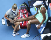 United States' Venus Williams receives treatment to leg injuries during her second round match against Italy's Sara Errani at the Australian Open tennis championship in Melbourne, Australia, Wednesday, Feb. 10, 2021.(AP Photo/Hamish Blair)