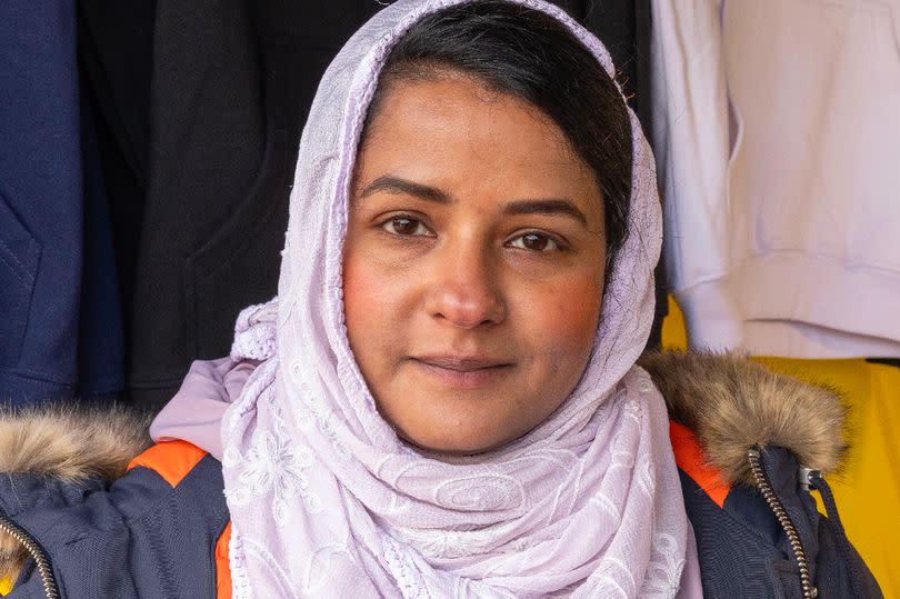 Shahana Shanu by her stall in Longsight market -Credit:Manchester Evening News