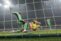 Atletico Madrid's goalkeeper Jan Oblak jumps for the ball as Inter Milan's Marko Arnautovic scores his side's opening goal during the Champions League, round of 16, first leg soccer match between Inter Milan and Atletico Madrid, at the San Siro stadium in Milan, Italy, Tuesday, Feb. 20, 2024. (AP Photo/Luca Bruno)