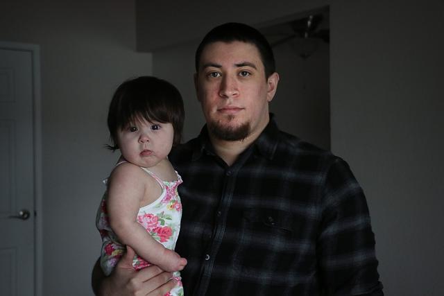 Elijah Johnson poses for a portrait with his daughter Azriela-Nova in their apartment in Reno on March 28, 2023.