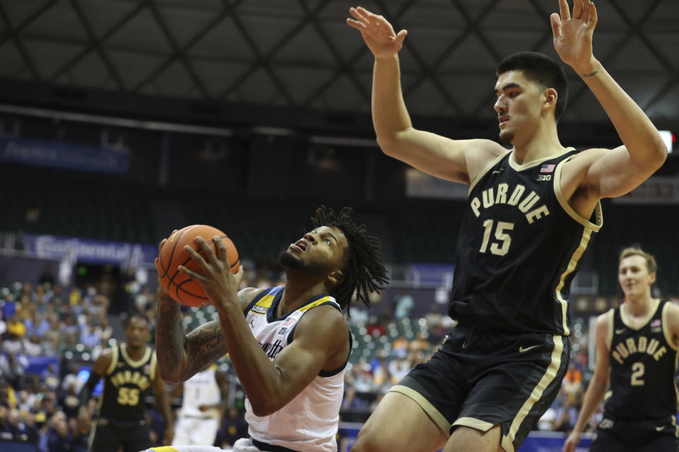 Marquette forward David Joplin tries to shoot over Purdue center Zach Edey (15) during the first half of an NCAA college basketball game, Wednesday, Nov. 22, 2023, in Honolulu. (AP Photo/Marco Garcia)