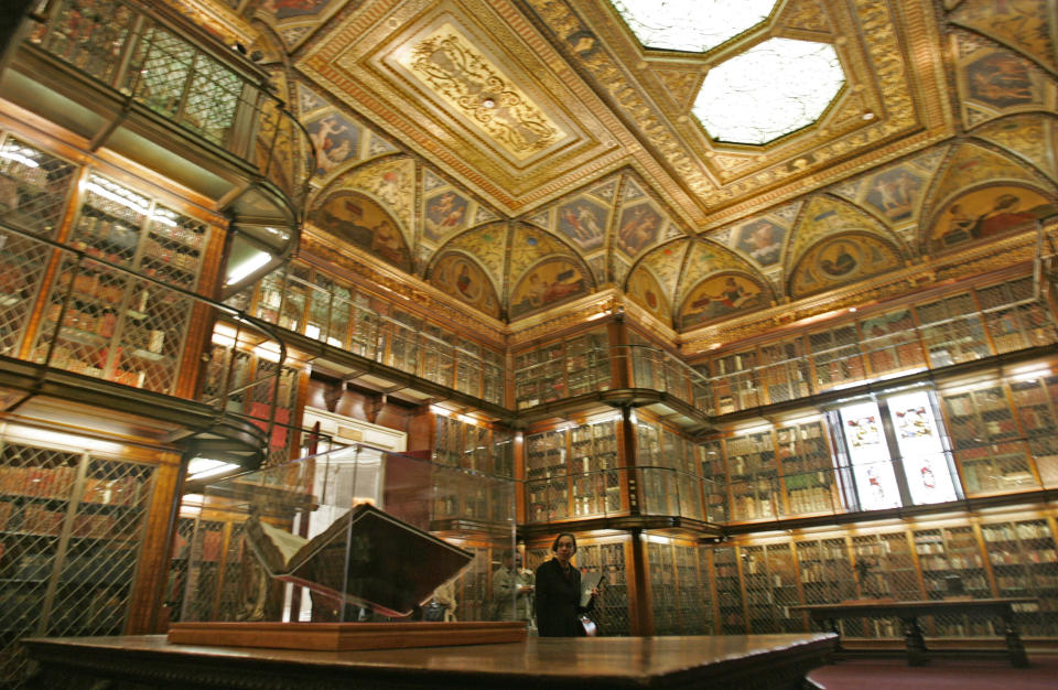 FILE - A 1455 Biblia Latina by Johannes Gutenberg and Johann Fust, foreground left, is on display inside the personal library of Pierpont Morgan, at the Morgan Library and Museum, in New York, April 25, 2006. Three times per year, a library curator turns the page. (AP Photo/Richard Drew, File)