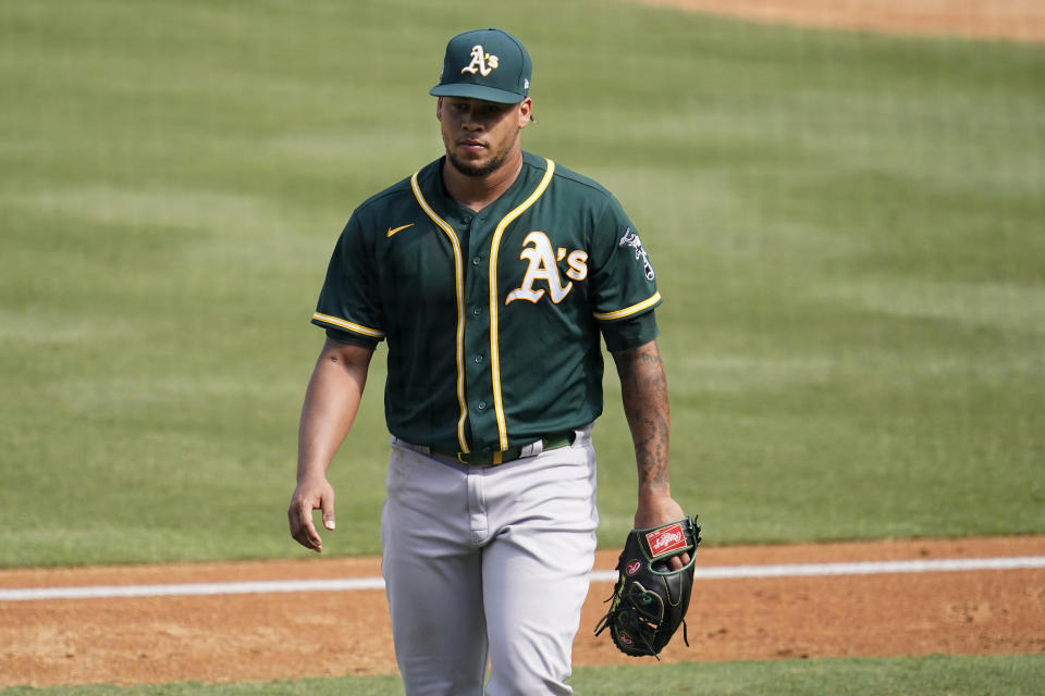 Oakland Athletics pitcher Frankie Montas walks to the dugout after being relieved during the fourth inning of Game 4 of a baseball American League Division Series against the Houston Astros in Los Angeles, Thursday, Oct. 8, 2020. (AP Photo/Marcio Jose Sanchez)