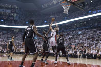 Toronto Raptors' Jonas Valanciunas shoots against the Brooklyn Nets during the first half of Game 1 of an opening-round NBA basketball playoff series, in Toronto on Saturday, April 19, 2014. (AP Photo/The Canadian Press, Chris Young)