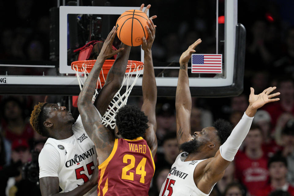 Iowa State forward Hason Ward (24) shoots against Cincinnati's Aziz Bandaogo and John Newman III during the first half of an NCAA college basketball game, Tuesday, Feb. 13, 2024, in Cincinnati. (AP Photo/Jeff Dean)