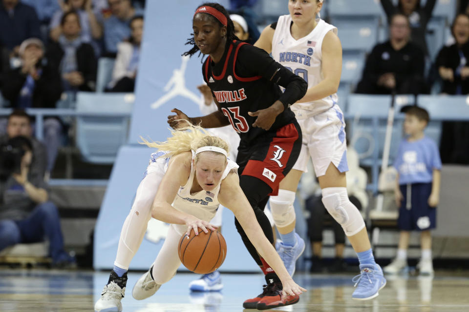 North Carolina guard Taylor Koenen dives to the floor while chasing the ball as Louisville guard Jazmine Jones (23) looks on during the second half of an NCAA college basketball game in Chapel Hill, N.C., Sunday, Jan. 19, 2020. (AP Photo/Gerry Broome)