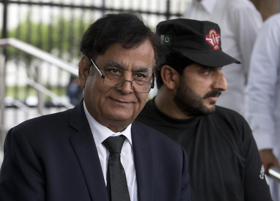 Saiful Malook, left, defense lawyer for Asia Bibi, a Pakistani Christian woman convicted of blasphemy, leaves the Supreme court with a bodyguard in Islamabad, Pakistan, Monday, Oct. 8, 2018. A three judge panel of Pakistan's Supreme Court on Monday postponed its ruling on a final appeal by Bibi, who has been on death row since 2010 on blasphemy charges. Malook pointed out contradictions in several statements given to support the charge of blasphemy. (AP Photo/B.K. Bangash)