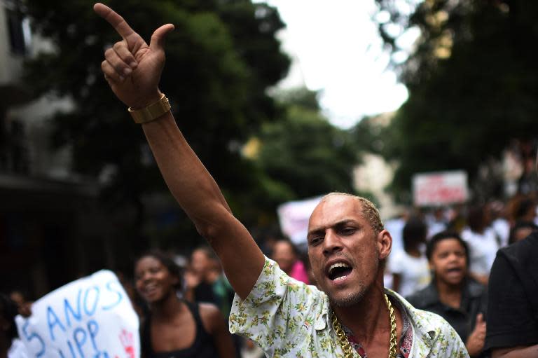 Friends of Douglas Rafael da Silva Pereira, 27, who was killed two days ago by the police, demonstrate in Rio de Janeiro before his funeral on April 24, 2014