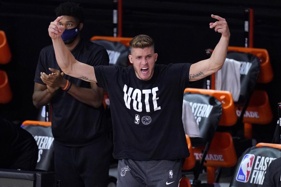 Miami Heat's Meyers Leonard (0) cheers on the team from the sideline during the second half of an NBA conference final playoff basketball game against the Boston Celtics on Saturday, Sept. 19, 2020, in Lake Buena Vista, Fla. (AP Photo/Mark J. Terrill)